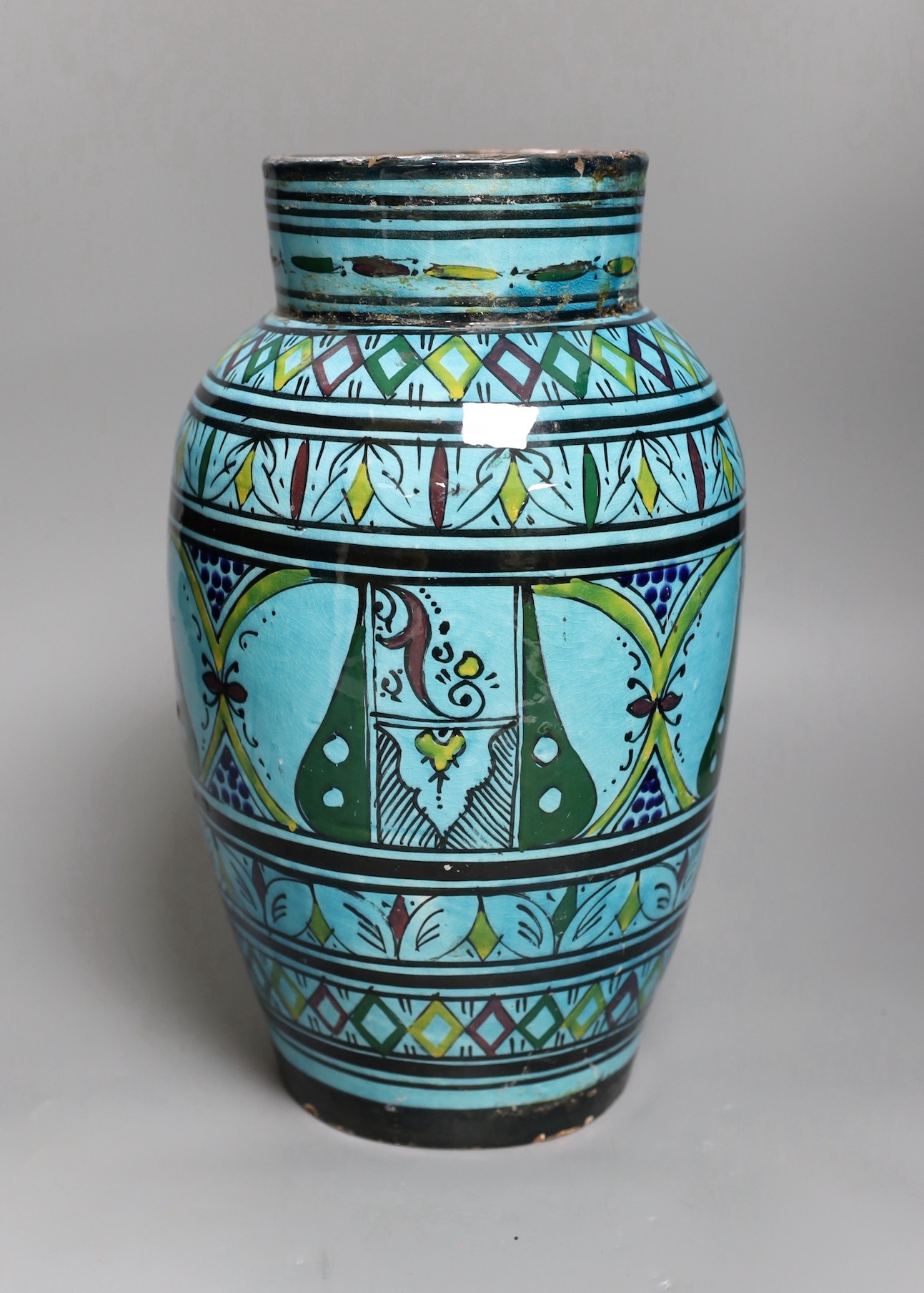 A large Persian ovoid painted terracotta vase, 34cm